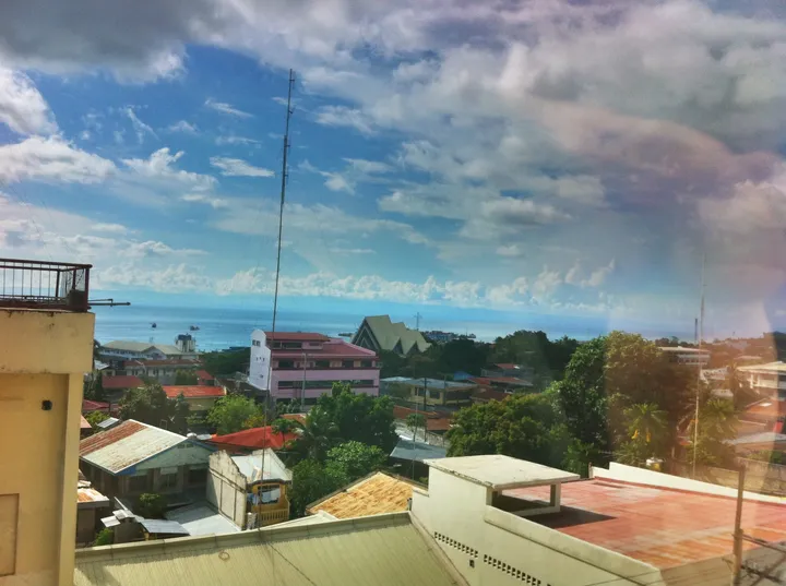 View of Bohol town rooftops with the ocean in the background